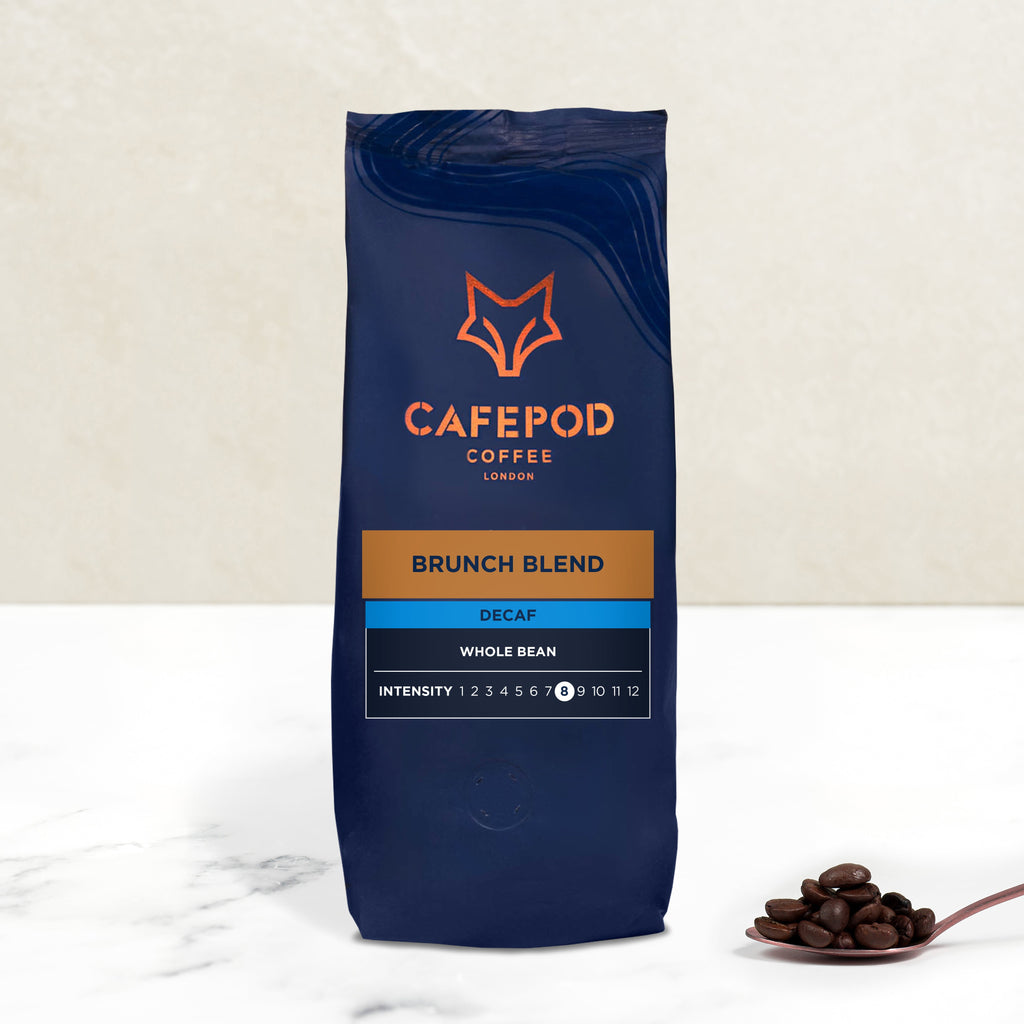A navy blue bag of CaféPod Coffee branded Brunch Blend Decaf whole bean coffee. The bag is labeled with the product name, intensity scale, and additional details.