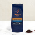 A navy blue bag of CaféPod Coffee branded Brunch Blend Decaf whole bean coffee. The bag is labeled with the product name, intensity scale, and additional details.