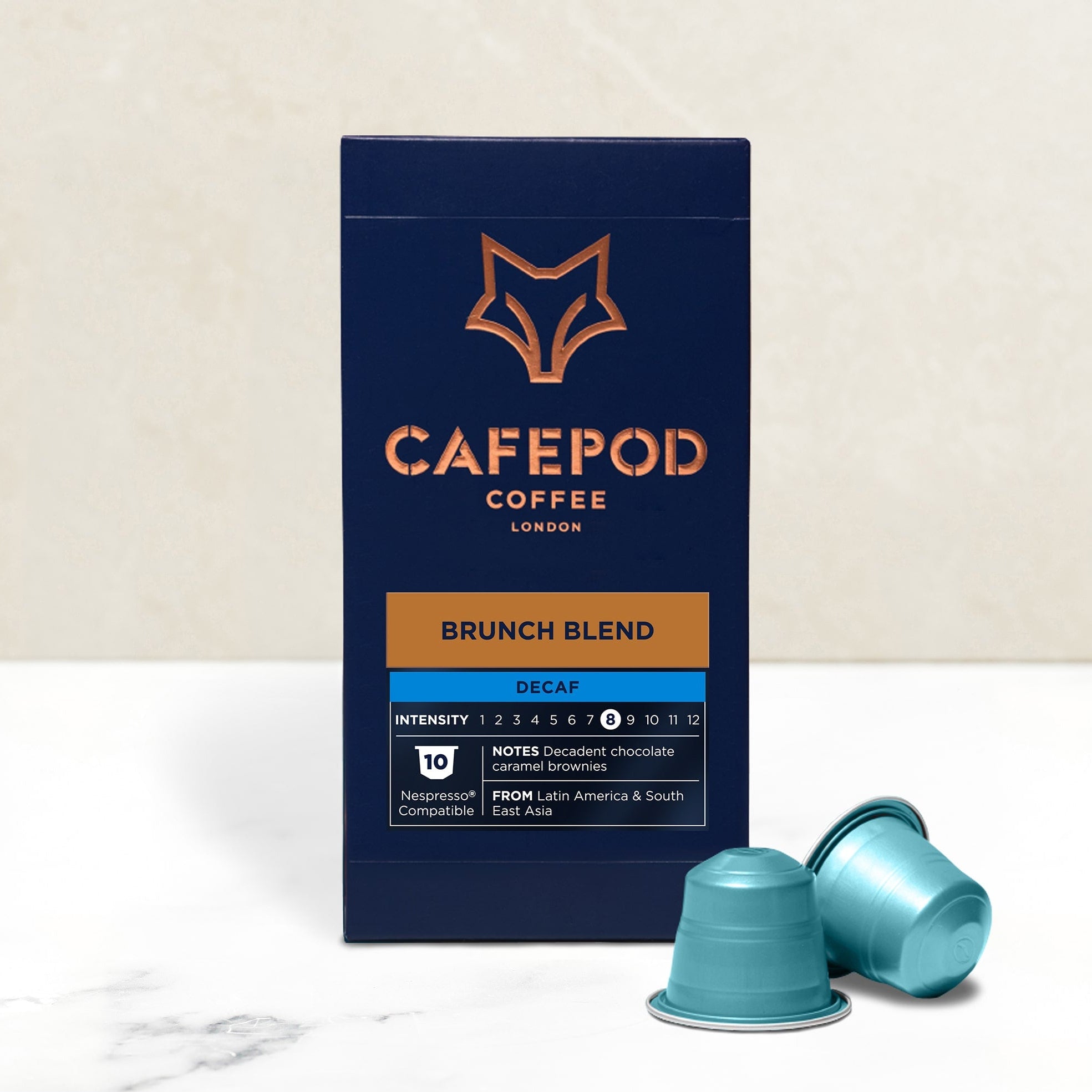 A box of CaféPod Coffee Brunch Blend decaf capsules with two capsules displayed in front, against a white background.
