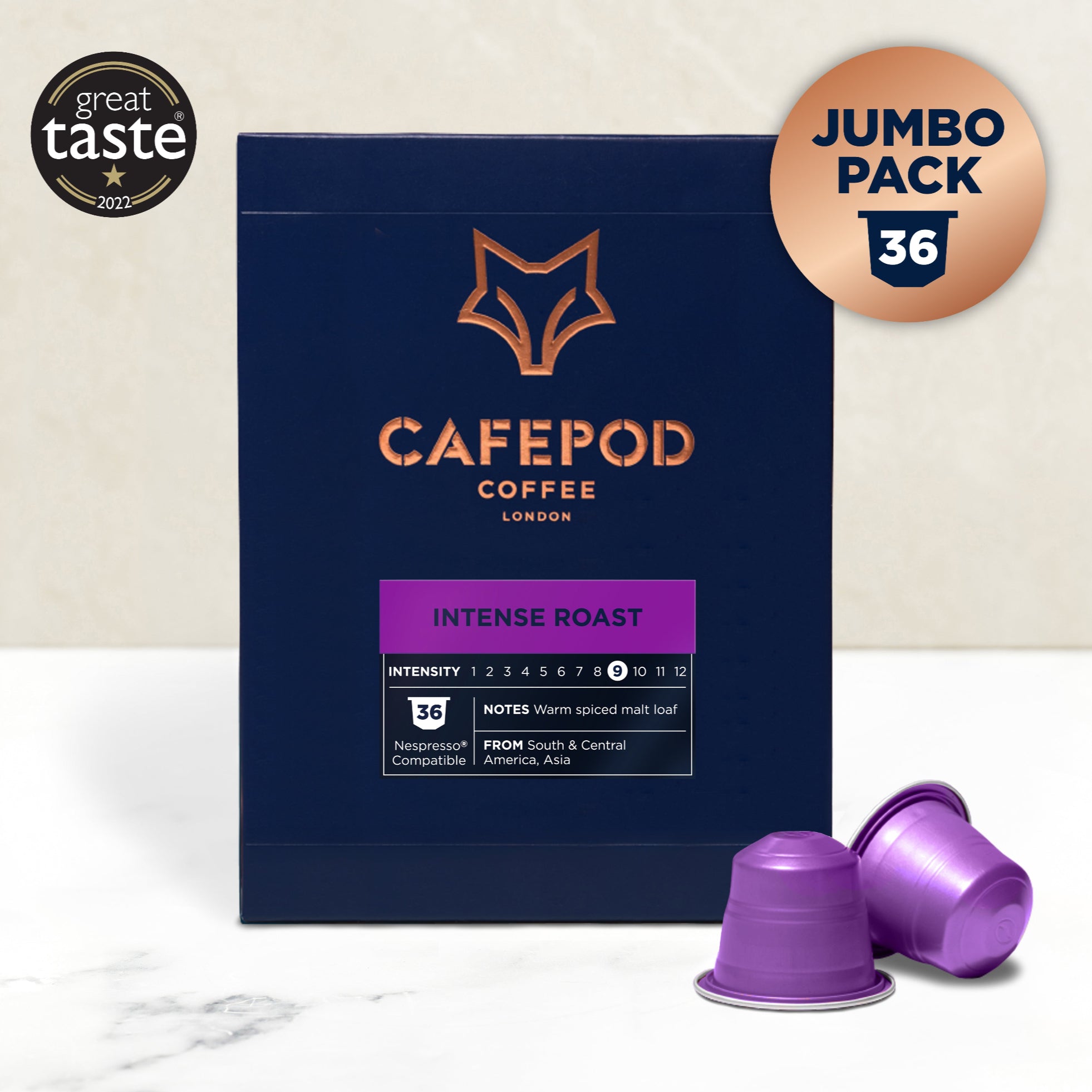 A navy blue box of Cafepod Coffee Intense Roast with a gold fox logo, accompanied by two purple coffee pods. The box indicates a jumbo pack of 36 and has taste intensity scoring.