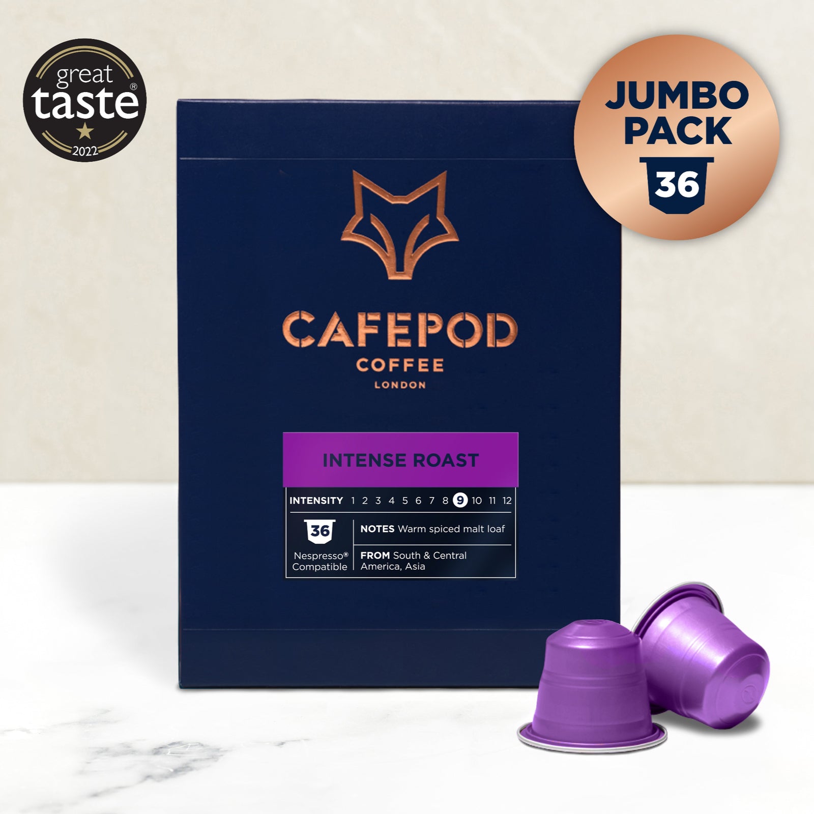 A navy blue box of Cafepod Coffee Intense Roast with a gold fox logo, accompanied by two purple coffee pods. The box indicates a jumbo pack of 36 and has taste intensity scoring.