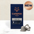 A box of Cafepod coffee capsules with the Smoky Joe variety shown. The box is dark blue with the product name and a fox logo, and there are capsules displayed in front of the box